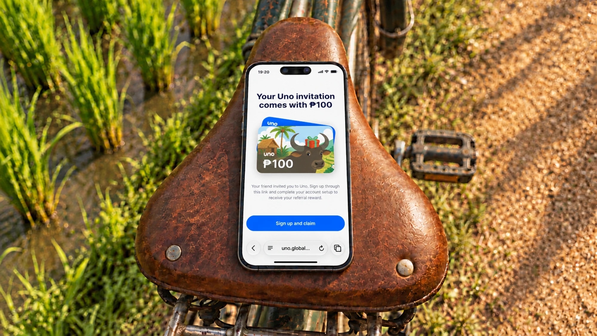 Uno referral invite on a phone resting on a bicycle seat
